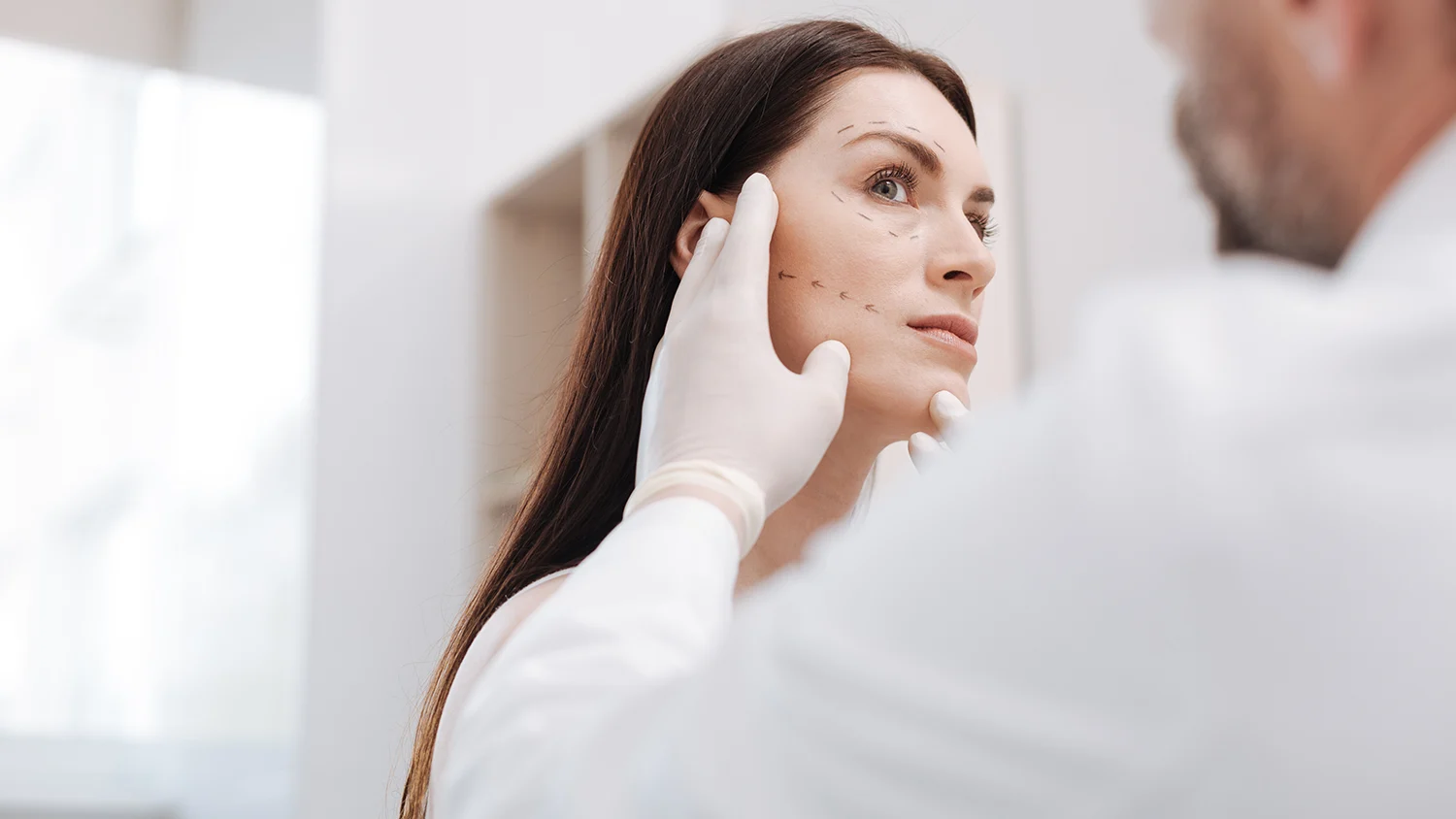 woman being seen by plastic surgeon