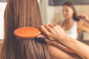 woman brushes thick hair