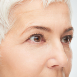 white haired woman looking off camera to expose profile