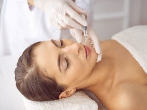 Woman receiving injection near the lips